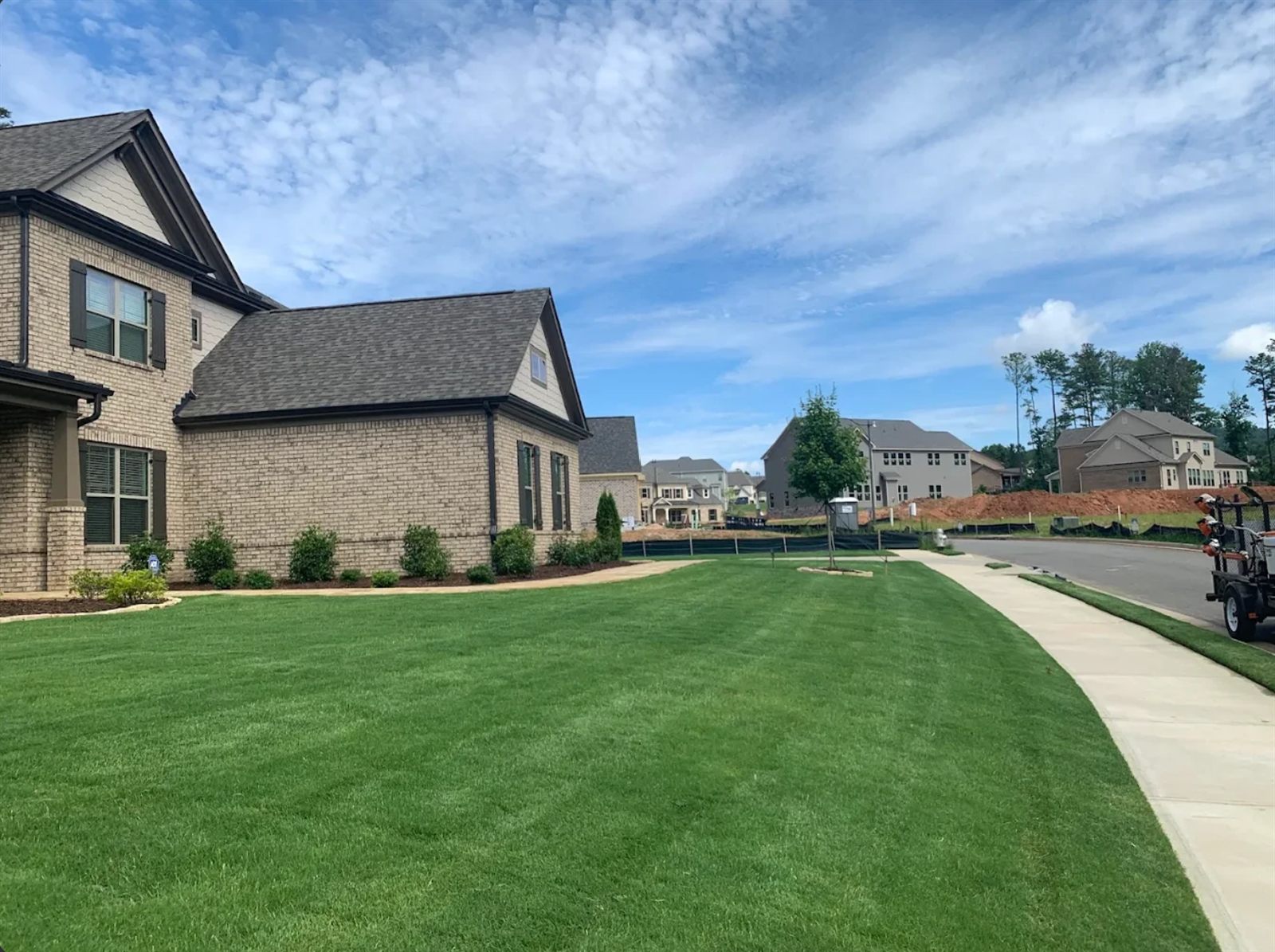 Freshly mowed, clean-striped front lawn by Mowtown in Powder Springs